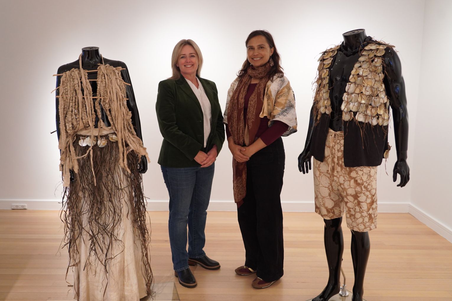 Delvene Cockatoo-Collins (right) and Redland City Mayor Jos Mitchell at Redland Art Gallery with the artist's garments. Mermaid in the Bay.