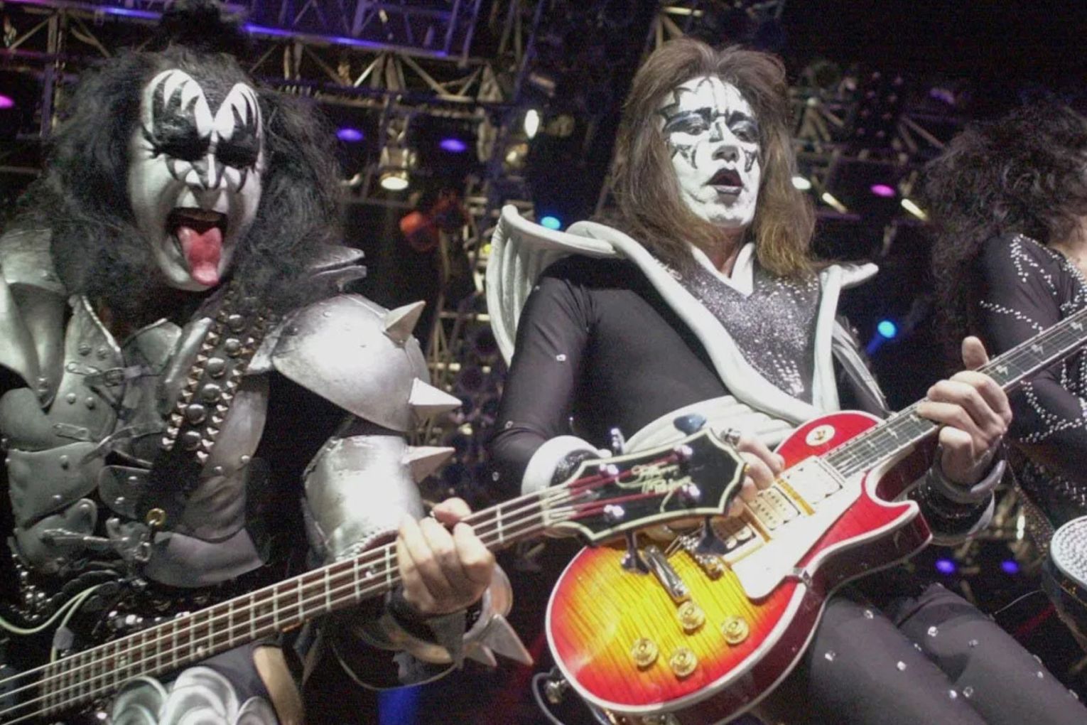 Guitarist Ace Frehley (centre) performing with his KISS bandmates in 2000. <i>Photo: PA</i>