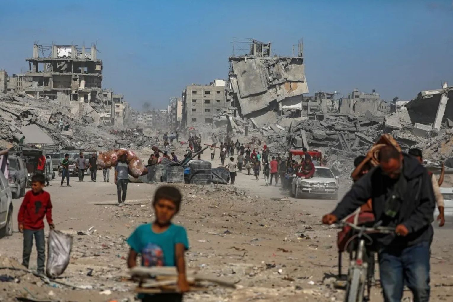 Palestinians among the rubble of destroyed buildings amid a ceasefire between Israel and Hamas.