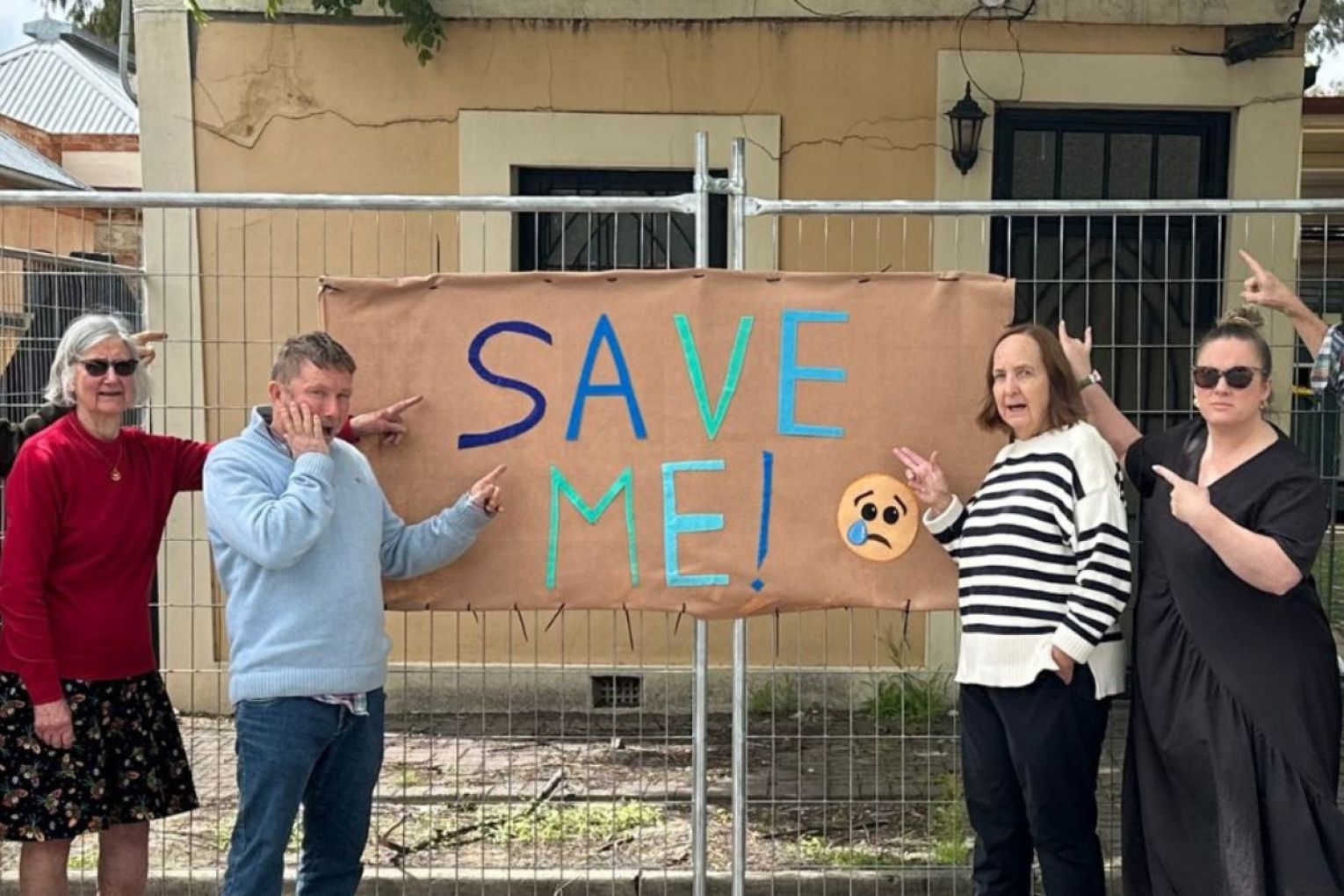 Members of the Kensington Residents Association with the property recommended for demolition. Photo: supplied. 
