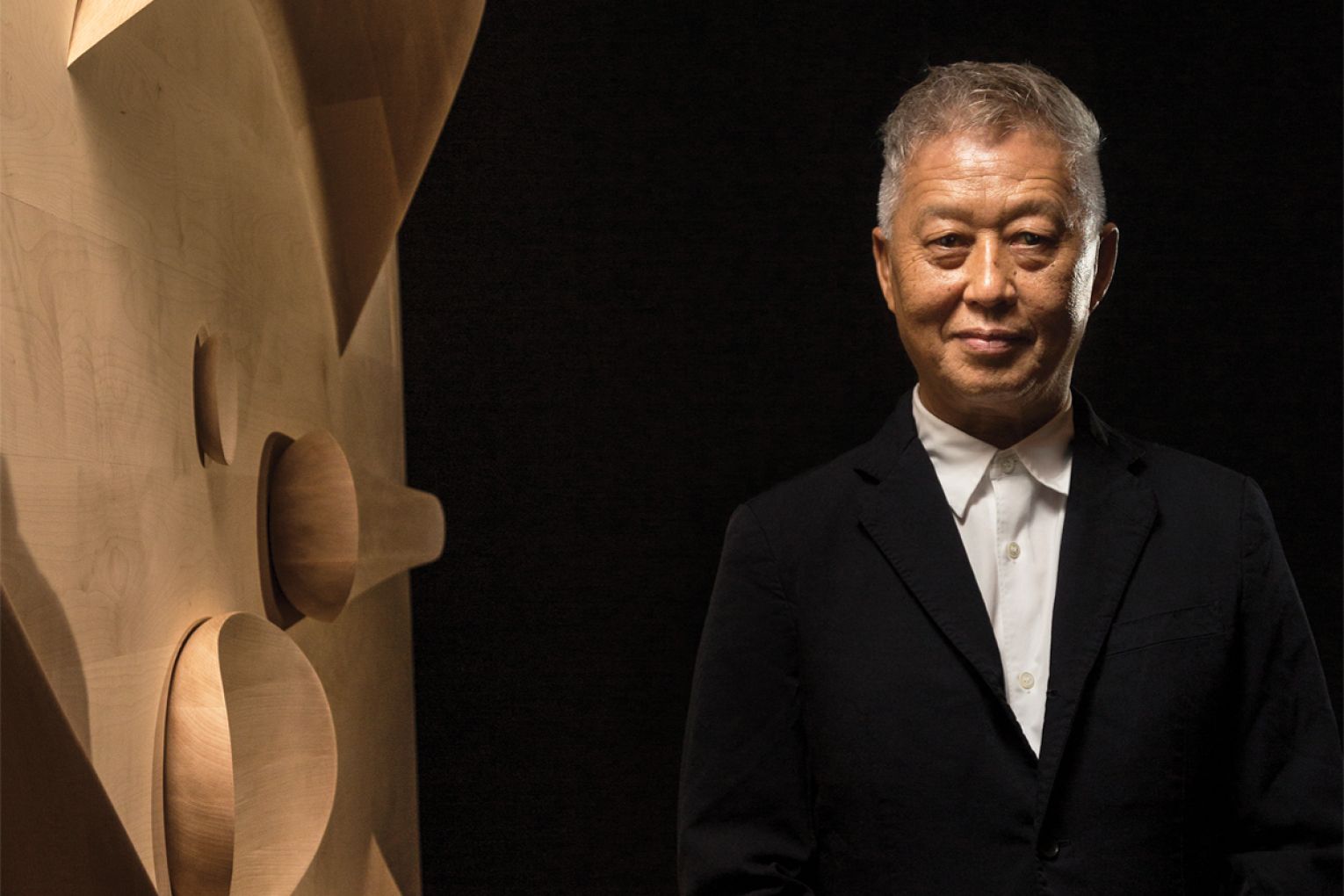 Khai with his work It was born like this in the 2018 Adelaide Biennial of Australian Art: Divided Worlds, Art Gallery of South Australia. Photograph Saul Steel.