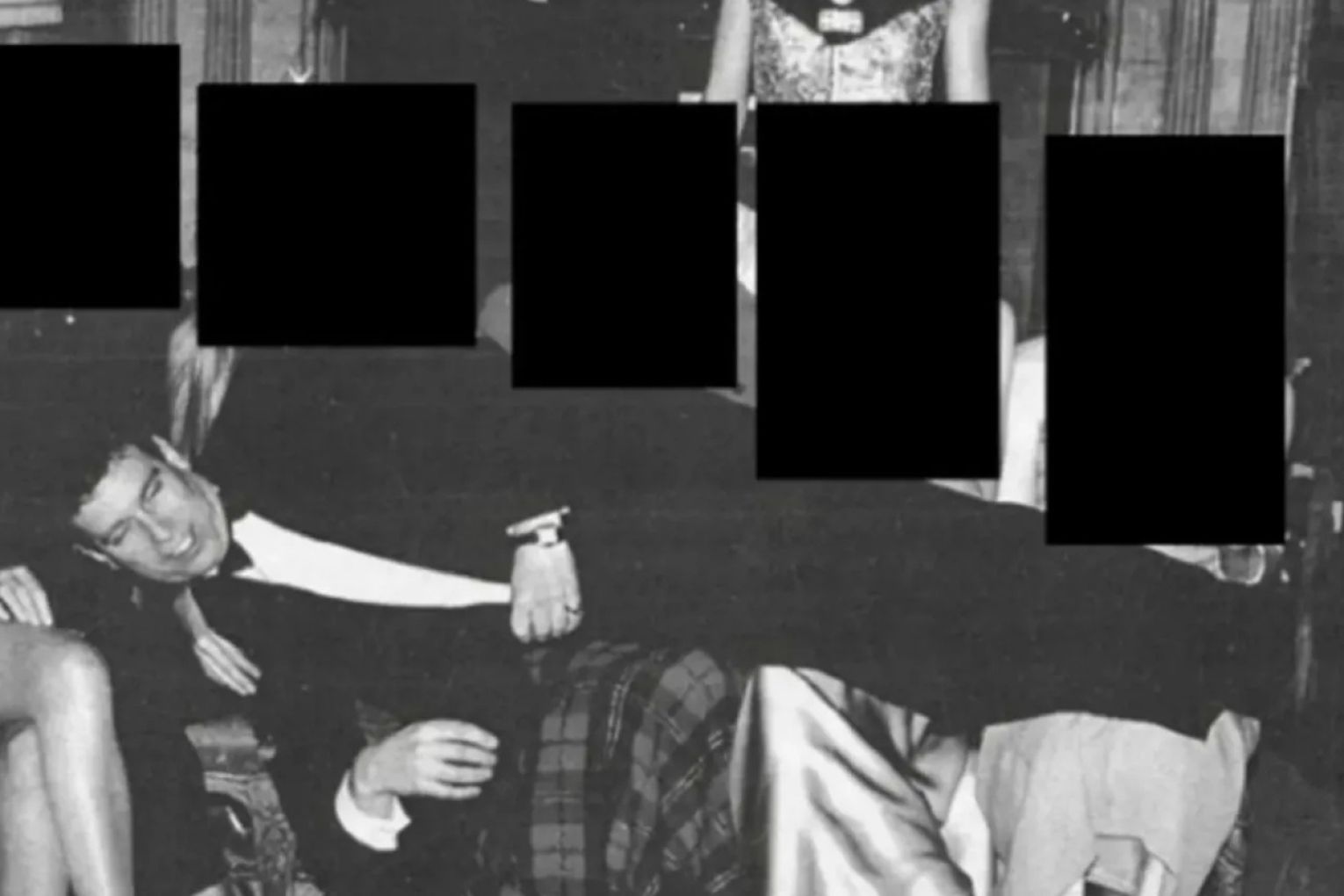 Andrew Mountbatten-Windsor lays on people's laps with Ghislaine Maxwell standing above. Photo: AAP