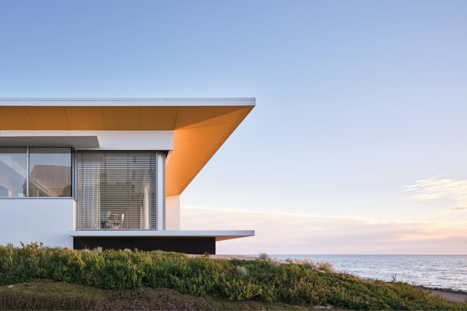 The home’s striking facade features a pop of yellow on the soffit.