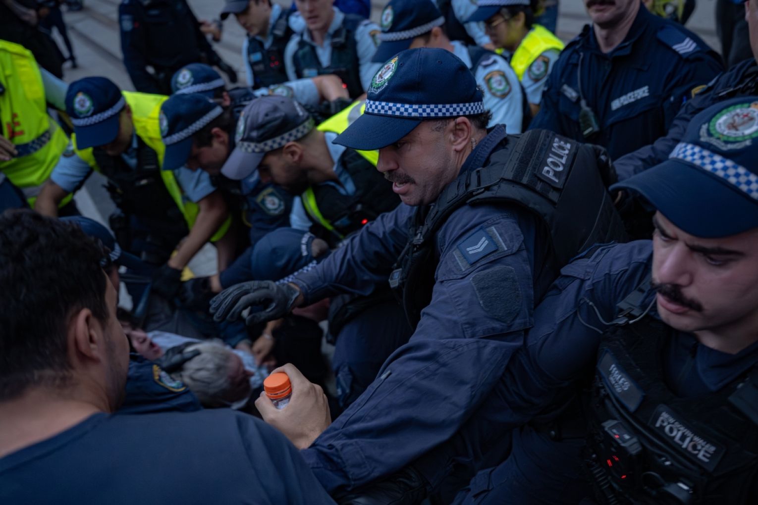 Police officers detain demonstrators during a protest near Sydney's Town Hall in Sydney, over a visit to Australia by Israeli President Isaac Herzog. Picture: AAP/Flavio Brancaleone