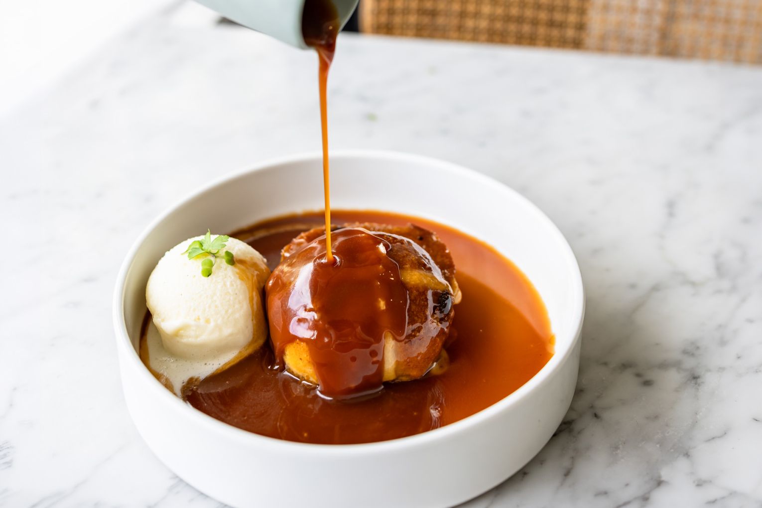 The sticky date hot cross bun with salted-caramel sauce, image credit: Jade Quinlivan