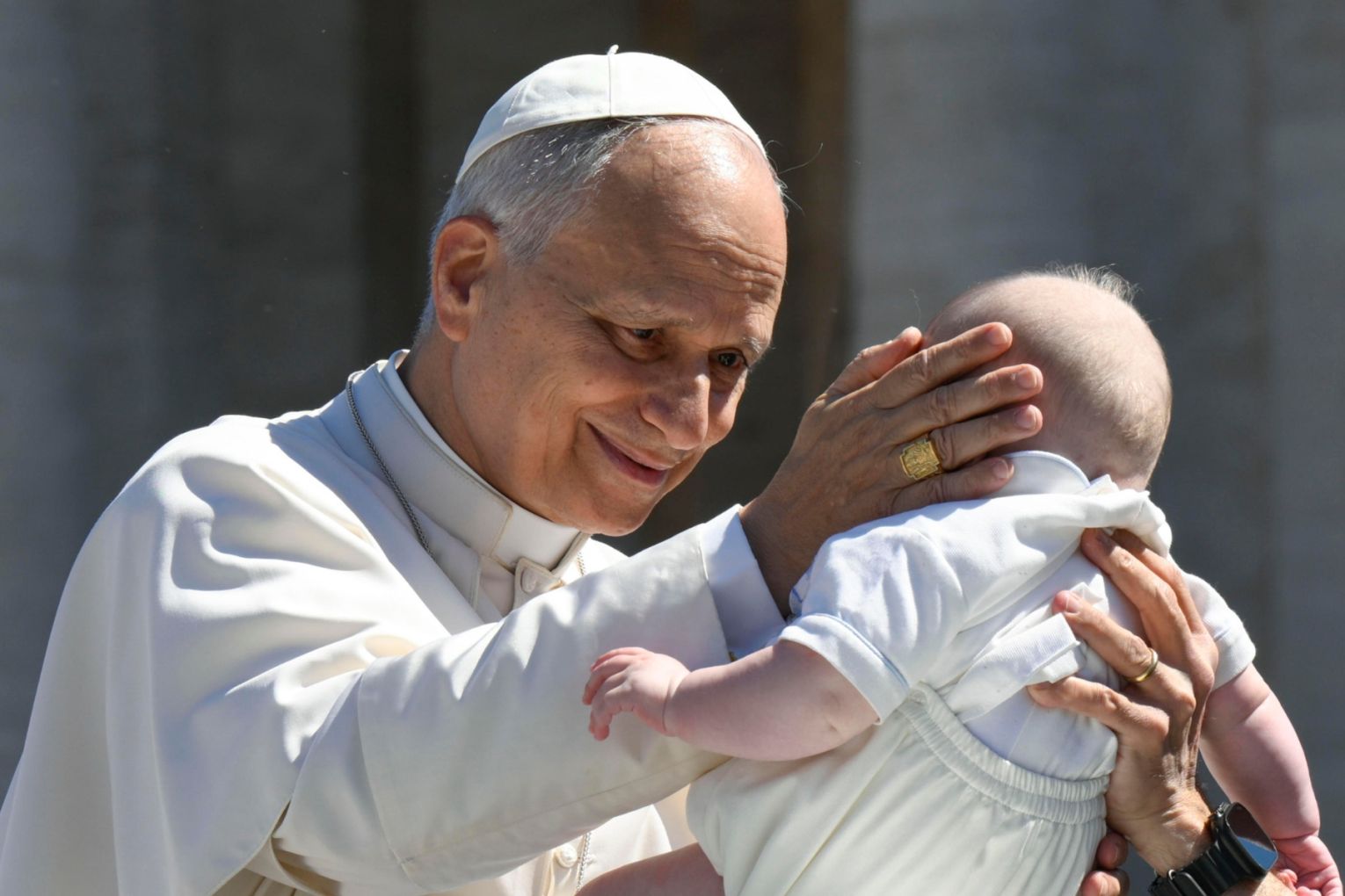 Pope Leo XIV holding a baby on the occasion of his Urbi et Orbi message after he presided over the Holy Mass on Easter Sunday at Saint Peter's Square in Vatican City. Picture: EPA/VATICAN MEDIA