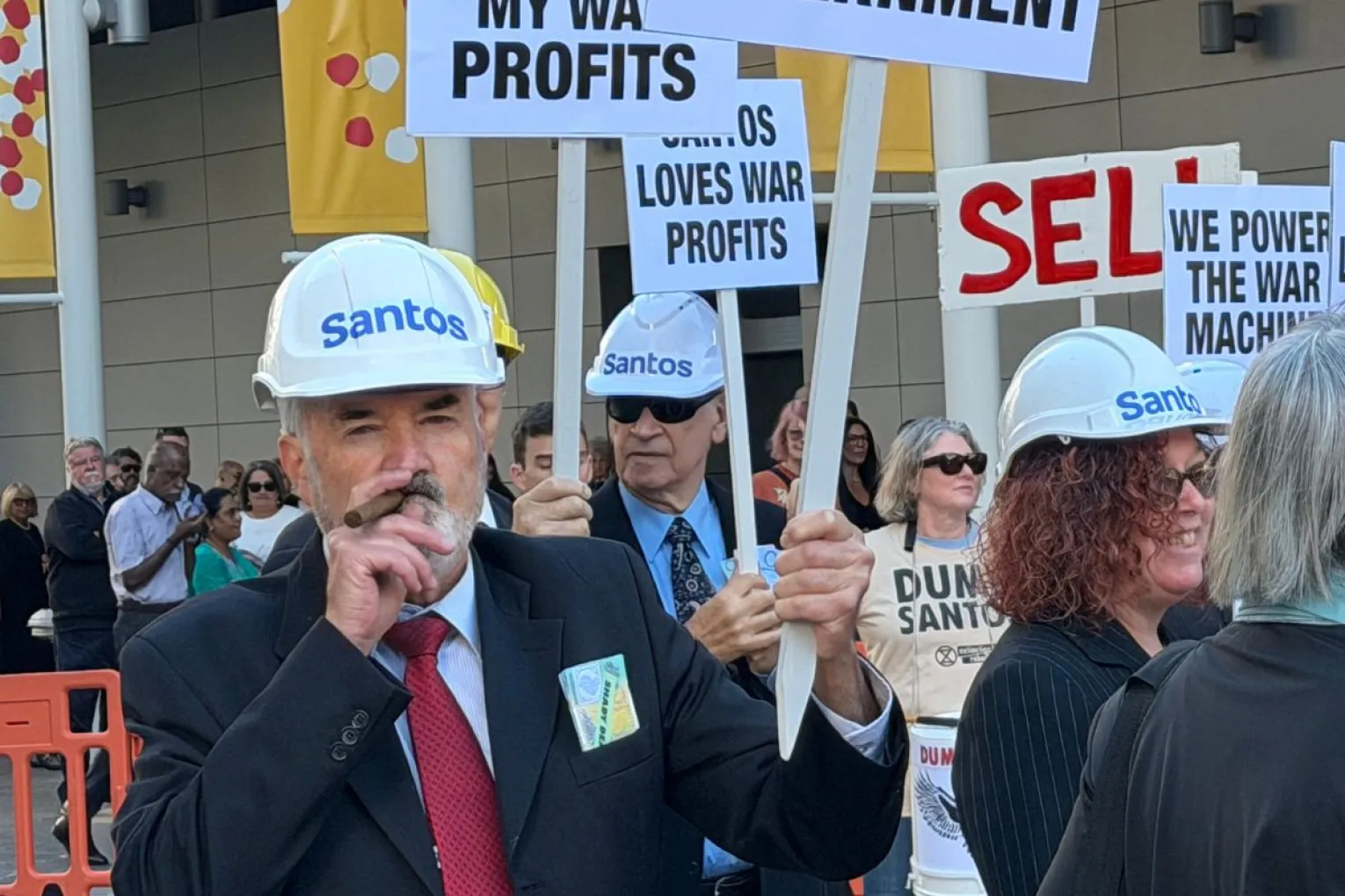 Protesters dressed as imitations of Santos bosses while picketing outside the Santos Annual General Meeting at the Convention Centre this morning. Picture: David Simmons/InDaily