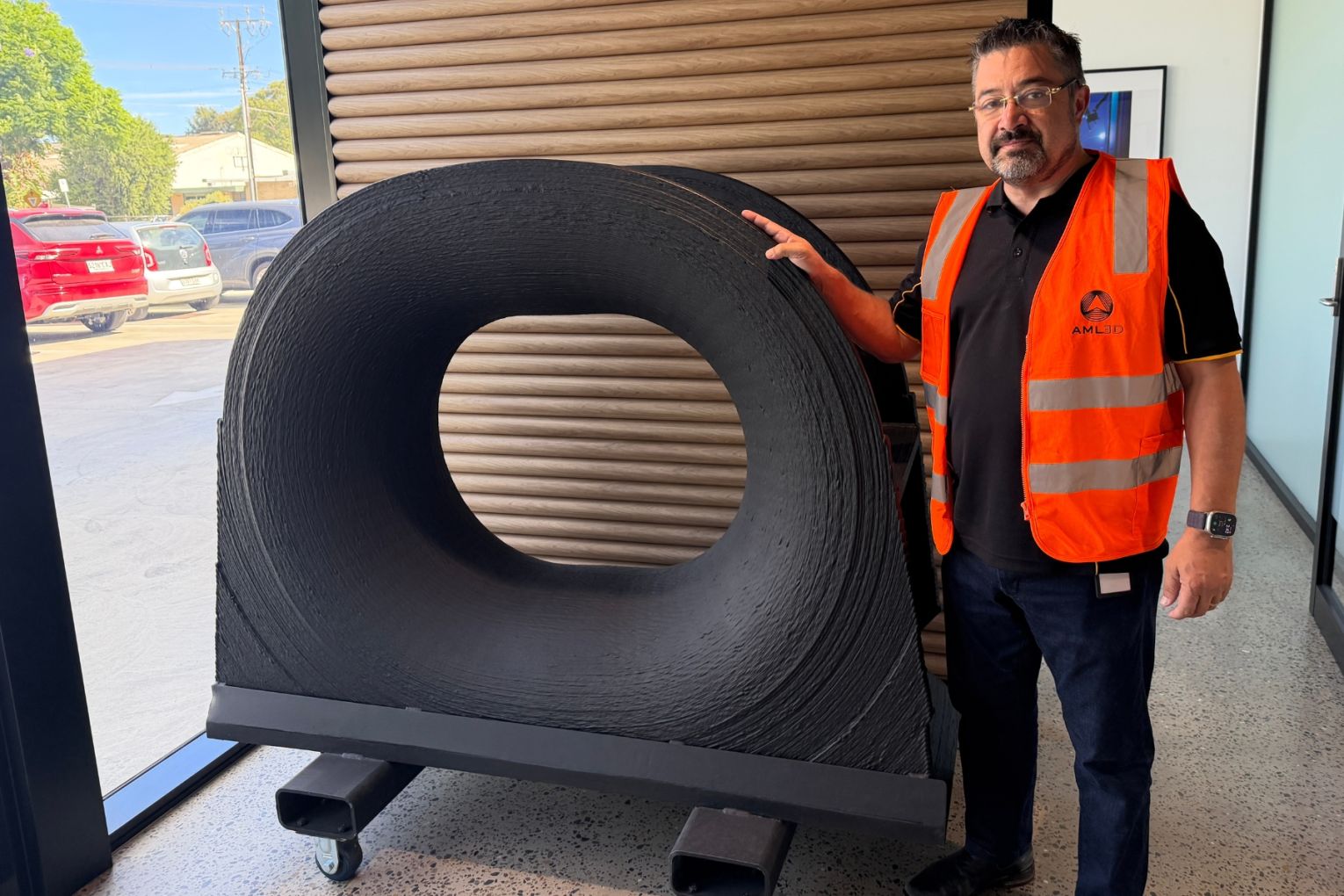 AML3D CEO Sean Ebert with a ship part 'printed' by the company's proprietary software. Photo: David Simmons