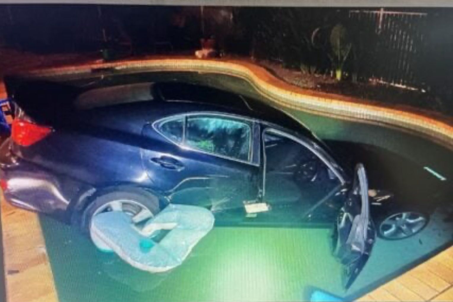 A man has been arrested and taken to hospital after allegedly driving a stolen car into the owner's pool. Picture: Queensland Police 