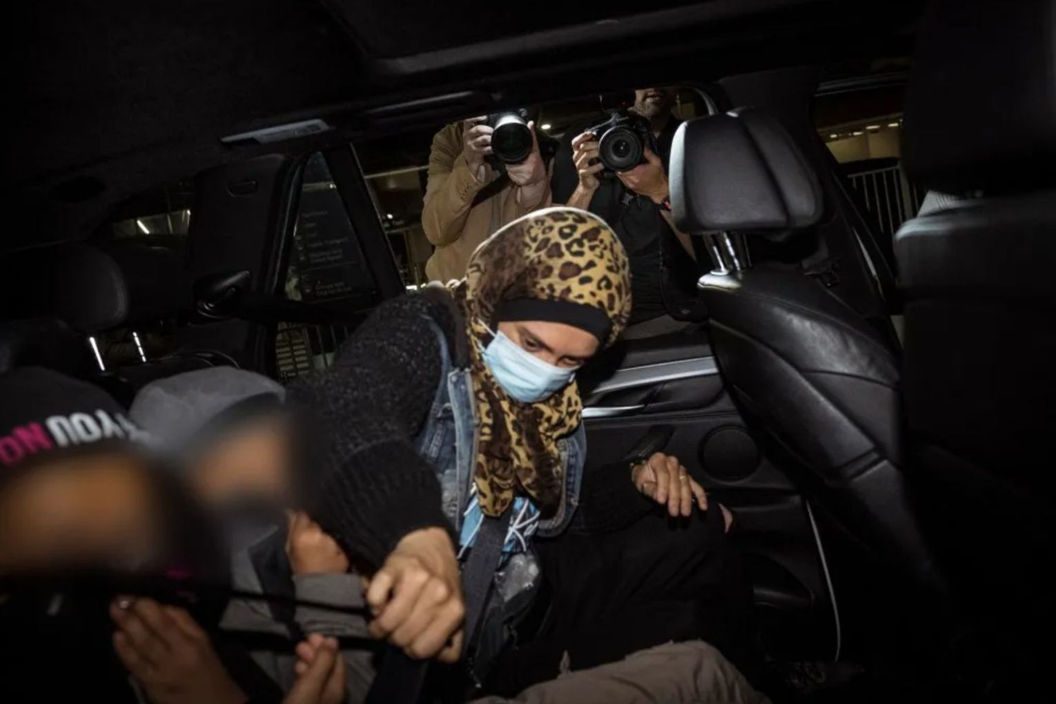 An Islamic State-linked family arrives at Melbourne International Airport  on Tuesday. 