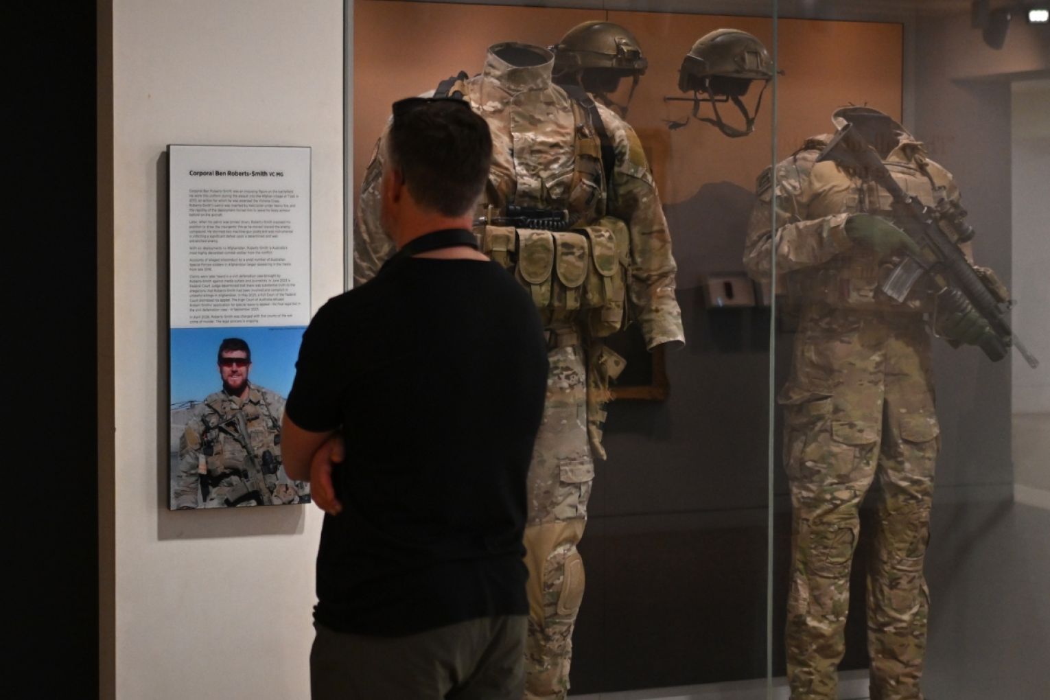 A visitor looks at a display featuring the uniform and medals of Ben Roberts-Smith at the Australian War Memorial, Canberra, Thursday, April 30, 2026. Picture: Lukas Coch