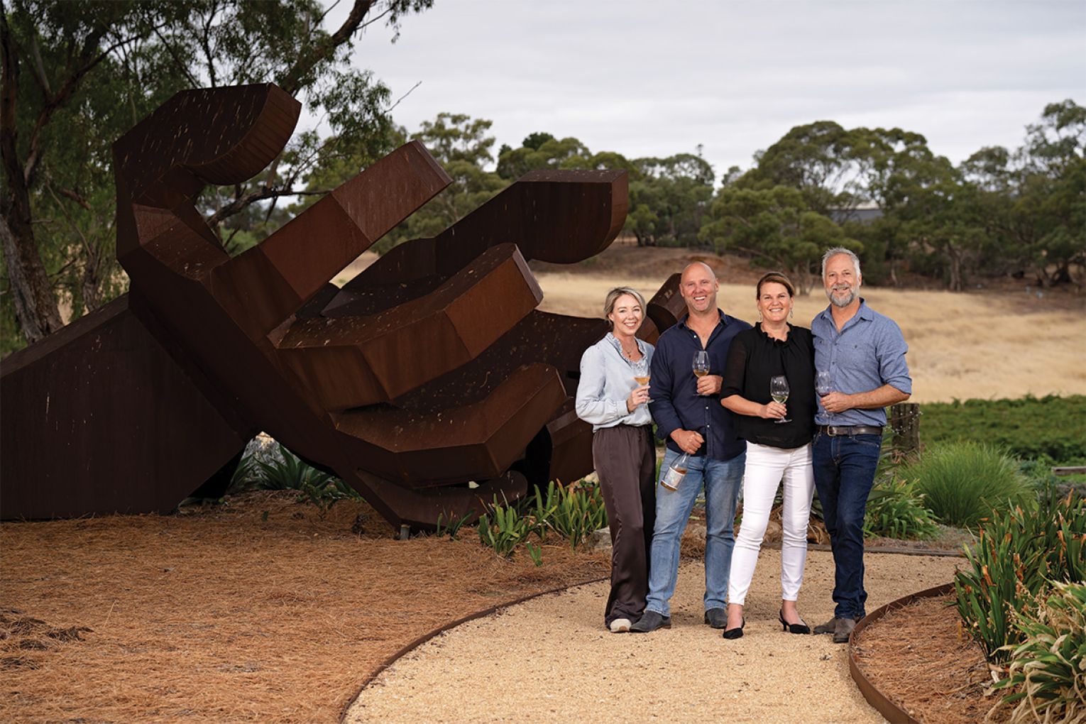 The industrious couples, from left, Renee and Luke and Kirsty and Nick, in front of sculpture “Harvest Hands”.