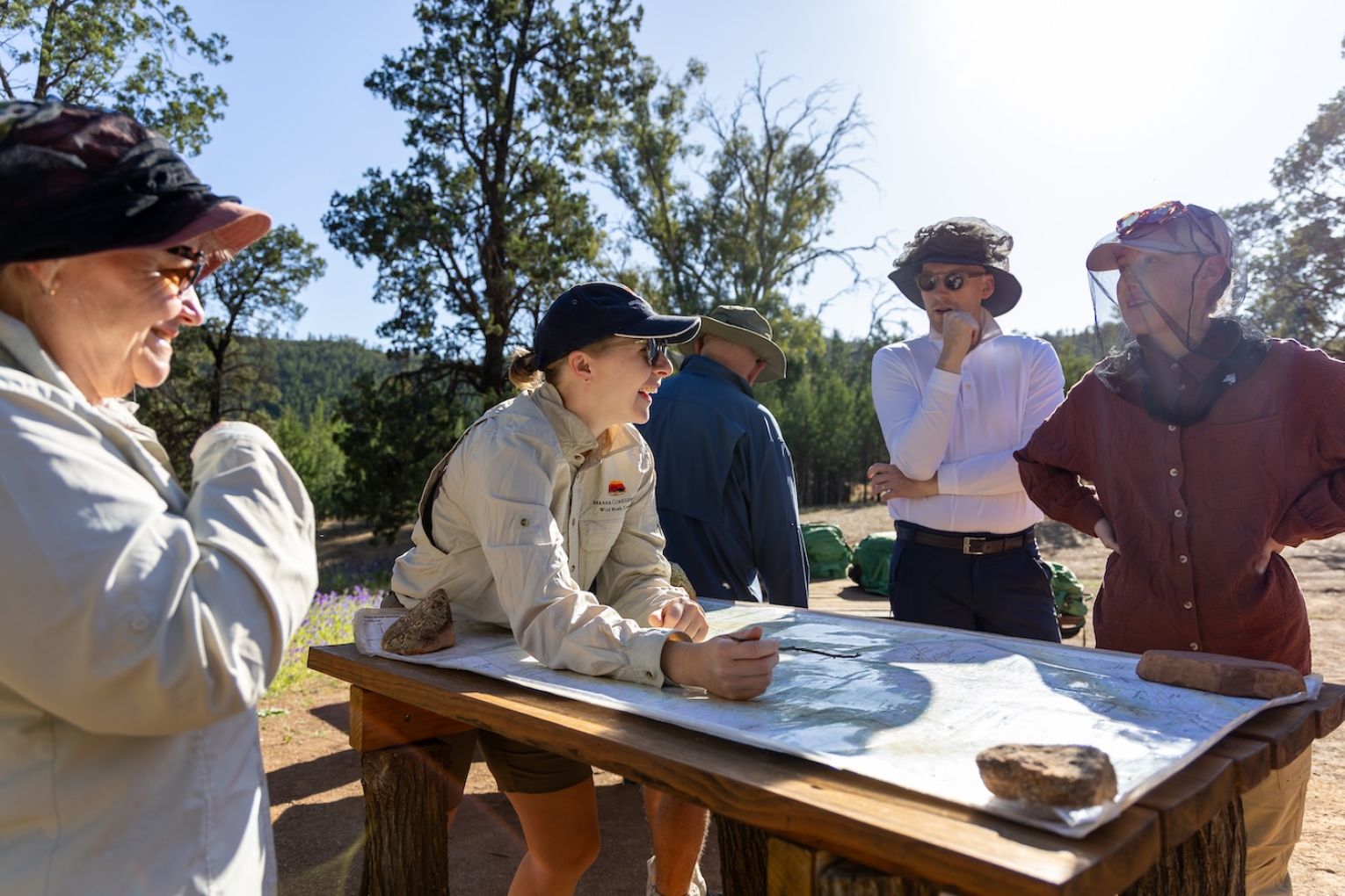 Arkaba field guide Natalie Gruhl gives a morning briefing to the hiking group; hikers have their own private swag quarters at each bush camp; the hike traverses ancient landscapes.