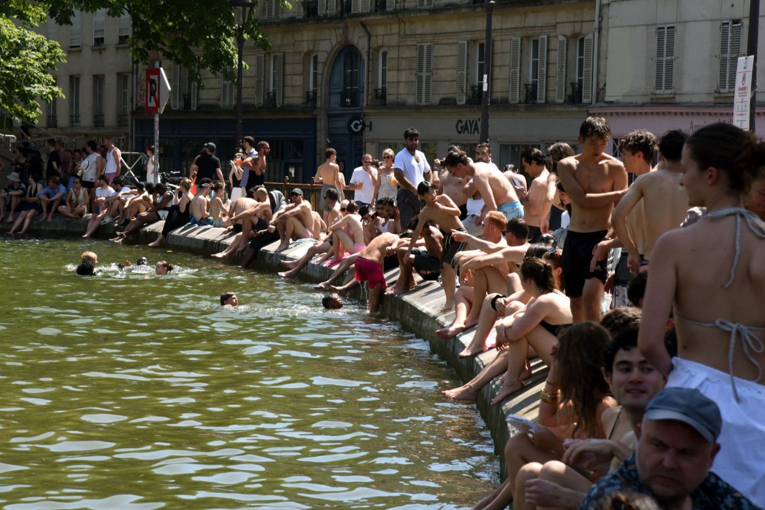 Cooling off in the Canal Saint-Martin amid a heatwave in Paris. Photo: AAP