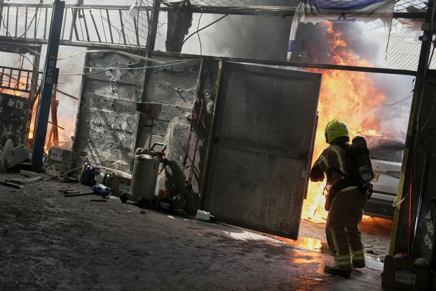 A firefighter battles flames at a damaged workshop after an alert of incoming missiles in Petah Tikva, Israel, Tuesday, March 31, 2026. Picture: AP Photo/Oded Balilty