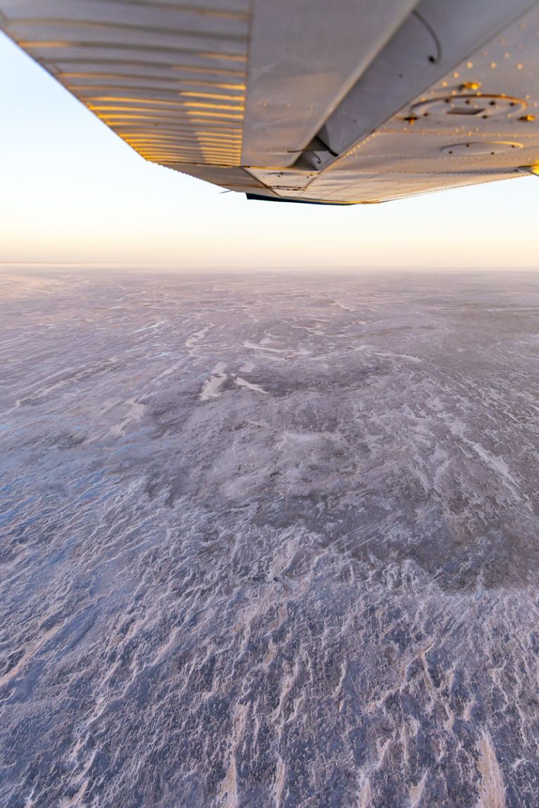 The sun begins to rise during a scenic flight over Lake Eyre.
