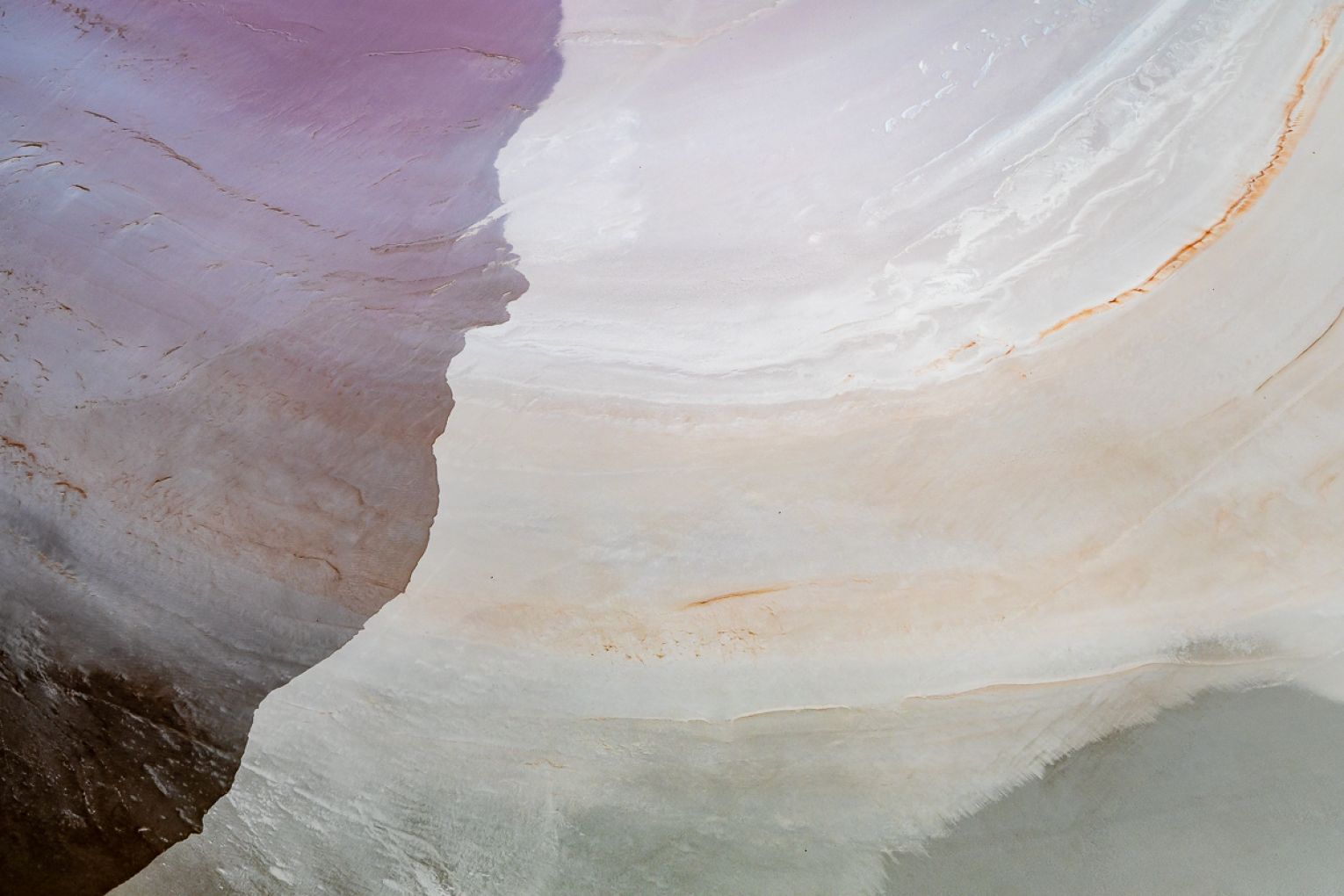 As rapid evaporation spikes salinity levels, it triggers a bloom of salt-loving algae that produce pink pigmentation, visible from space.
