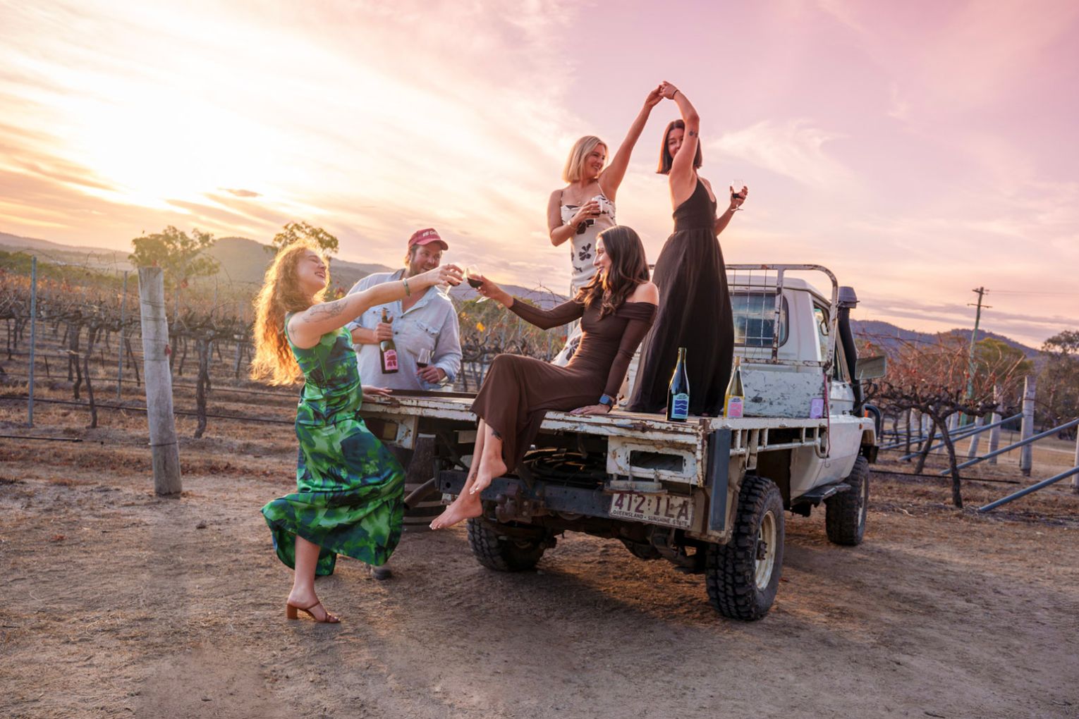 Nothing says Queensland Country like a sunset wine tasting on the back of the ute at the Dear Vincent vineyard, located in the Southern Downs & Granite Belt region. Credit: image supplied