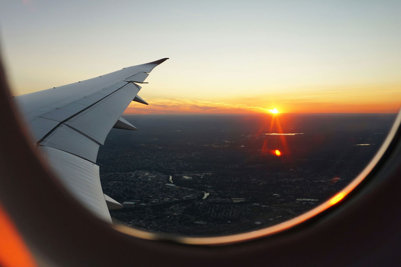 View from a plane window at sunset | Credit: Eva Darron via Unsplash