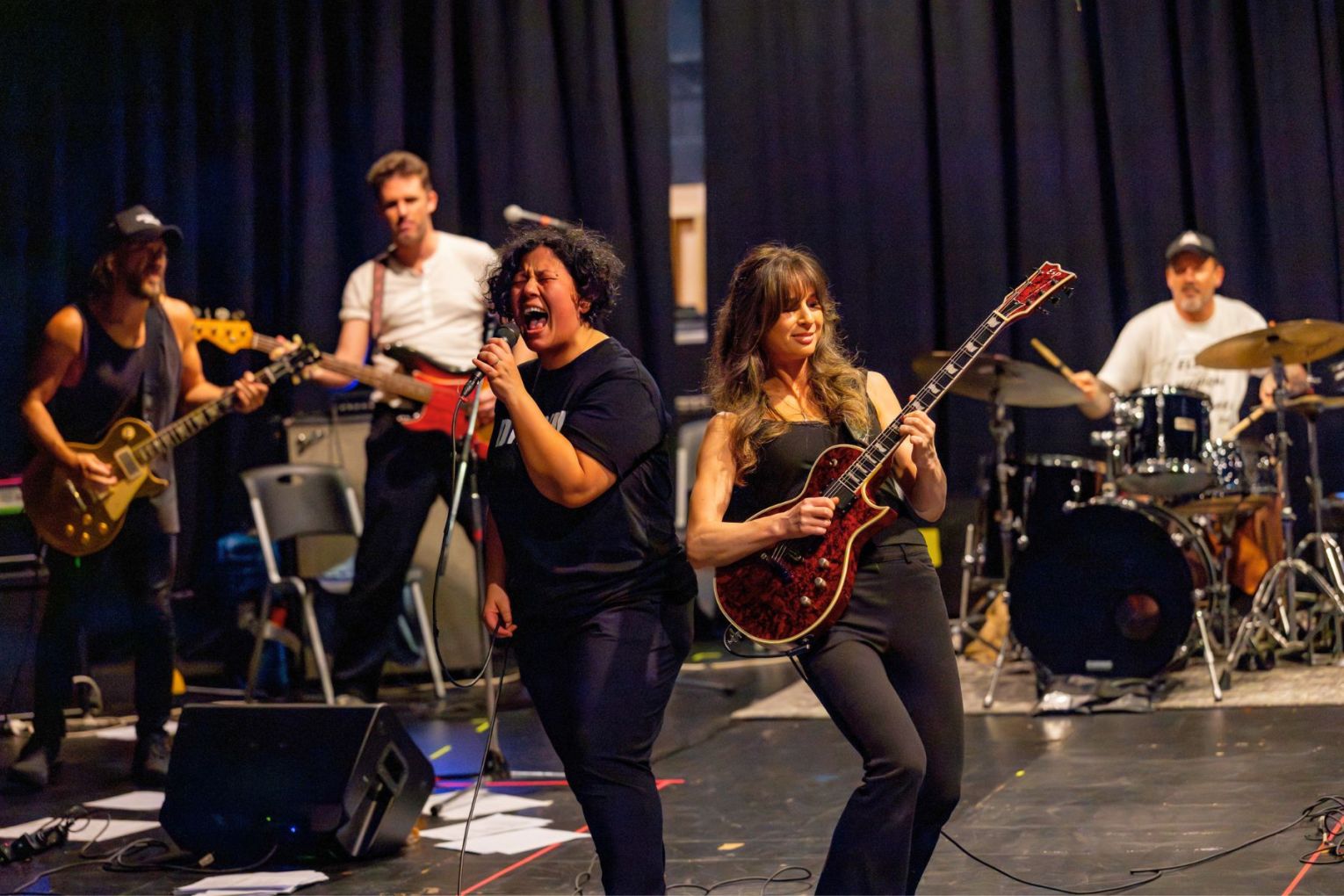 Mahalia Barnes (with microphone) is headlining Highway to Hell: The Rock 'N' Roll Circus at Wynnum Fringe.