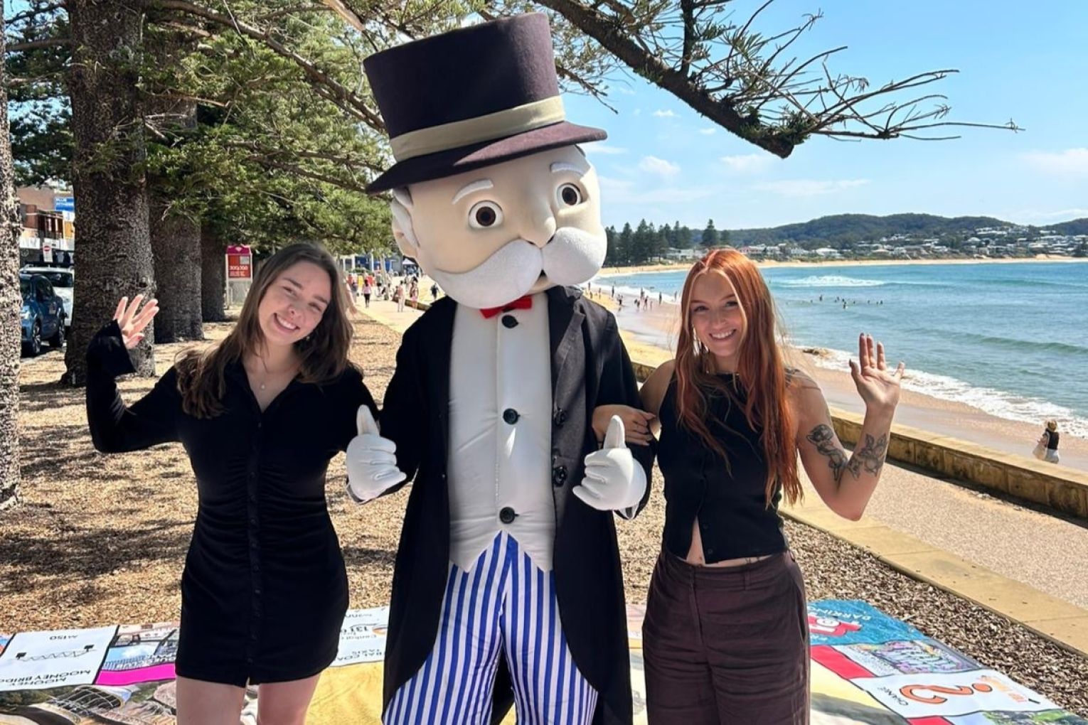 Louis Grundy and Lily Slaviero with Mr. Monopoly at the Central Coast in NSW, which also has its own Monopoly board. Photo: Supplied 