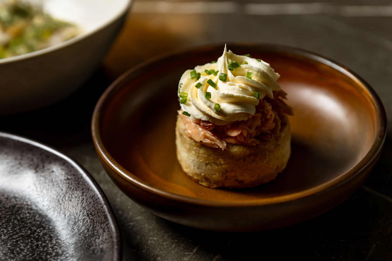 Barley crumpet topped with rainbow trout, creme fraiche and chives | Credit: James Frostick