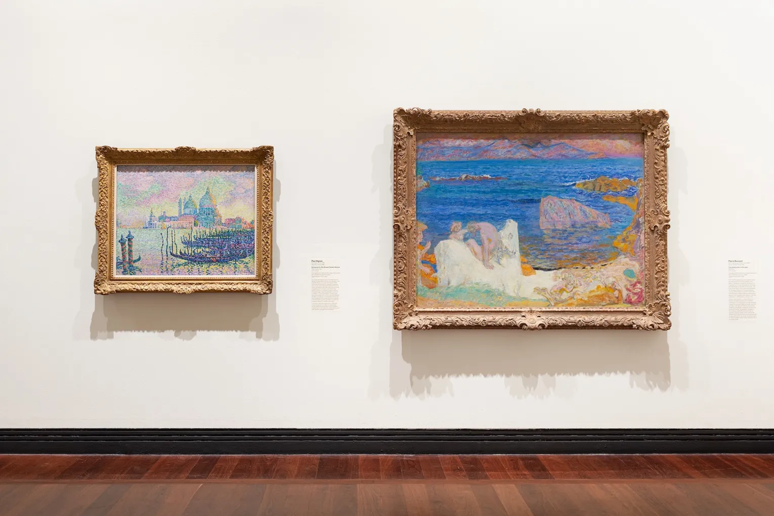 Installation view: Monet to Matisse: Defying Tradition, 2026, featuring Entrance to the Grand Canal by Paul Signac and The Abduction of Europa by Pierre Bonnard, Art Gallery of South Australia, Adelaide. Photo: Saul Steed / Supplied