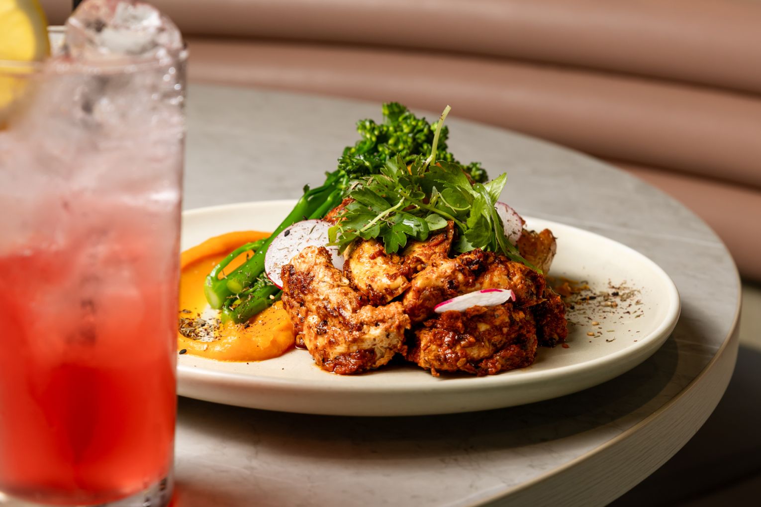 The Aviary's harissa-marinated chicken with smashed baby chat potatoes and grilled broccolini is a feast for all senses | Credit: James Frostick