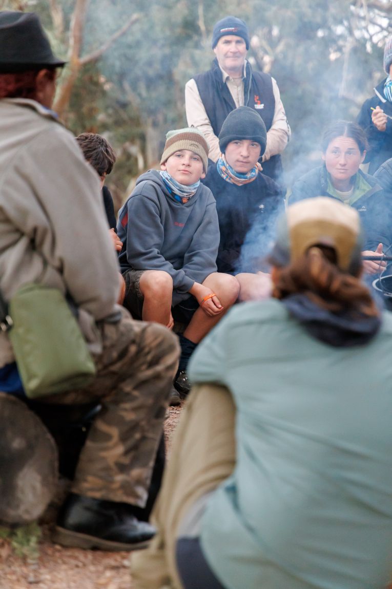 Students from Central Yorke School gather around the campfire to listen to an Indigenous elder.